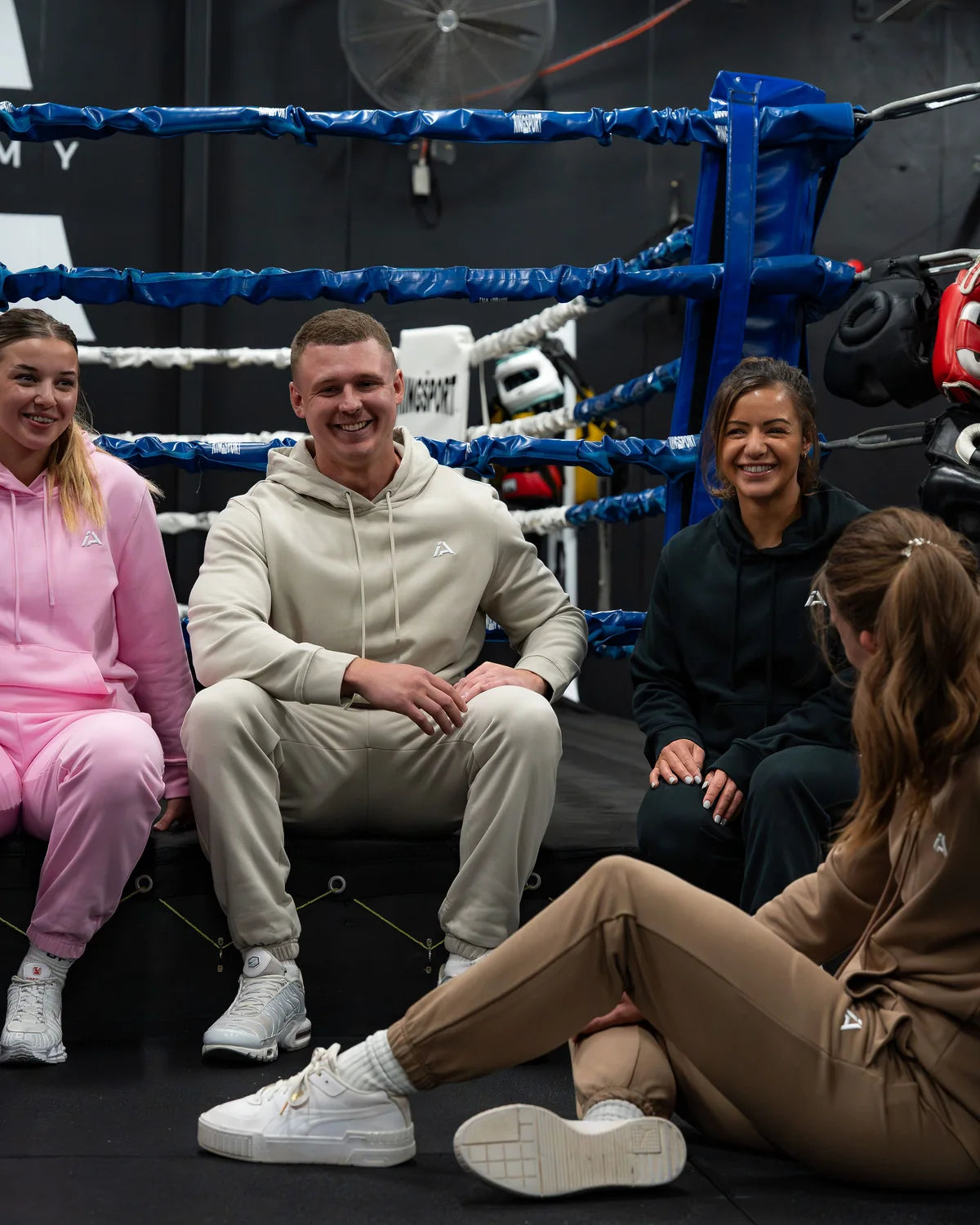 Iron Affinity community in training and lounge wear at a gym