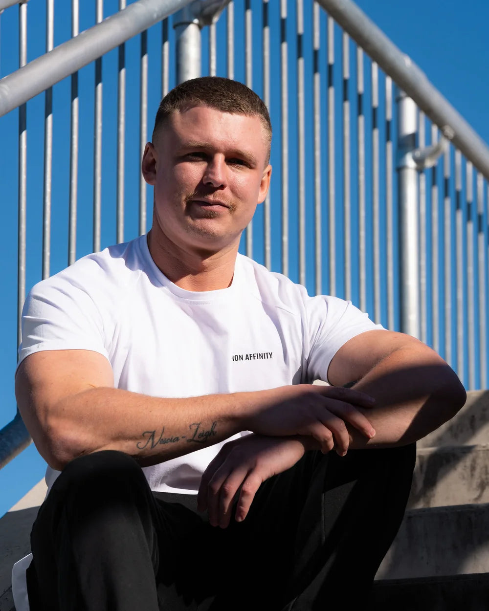 Man wearing a white Iron Affinity fitted training tee